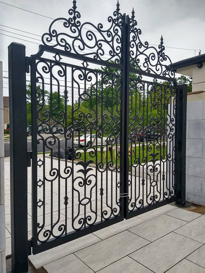 Ornamental black double entry gate at a residential property