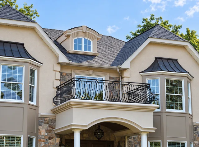 Black specialty railing with shaped belly pickets on a finished residential balcony